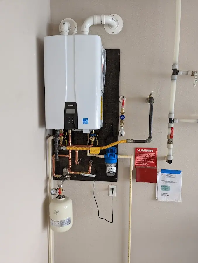 Professional plumber installing copper piping in a Amenia home